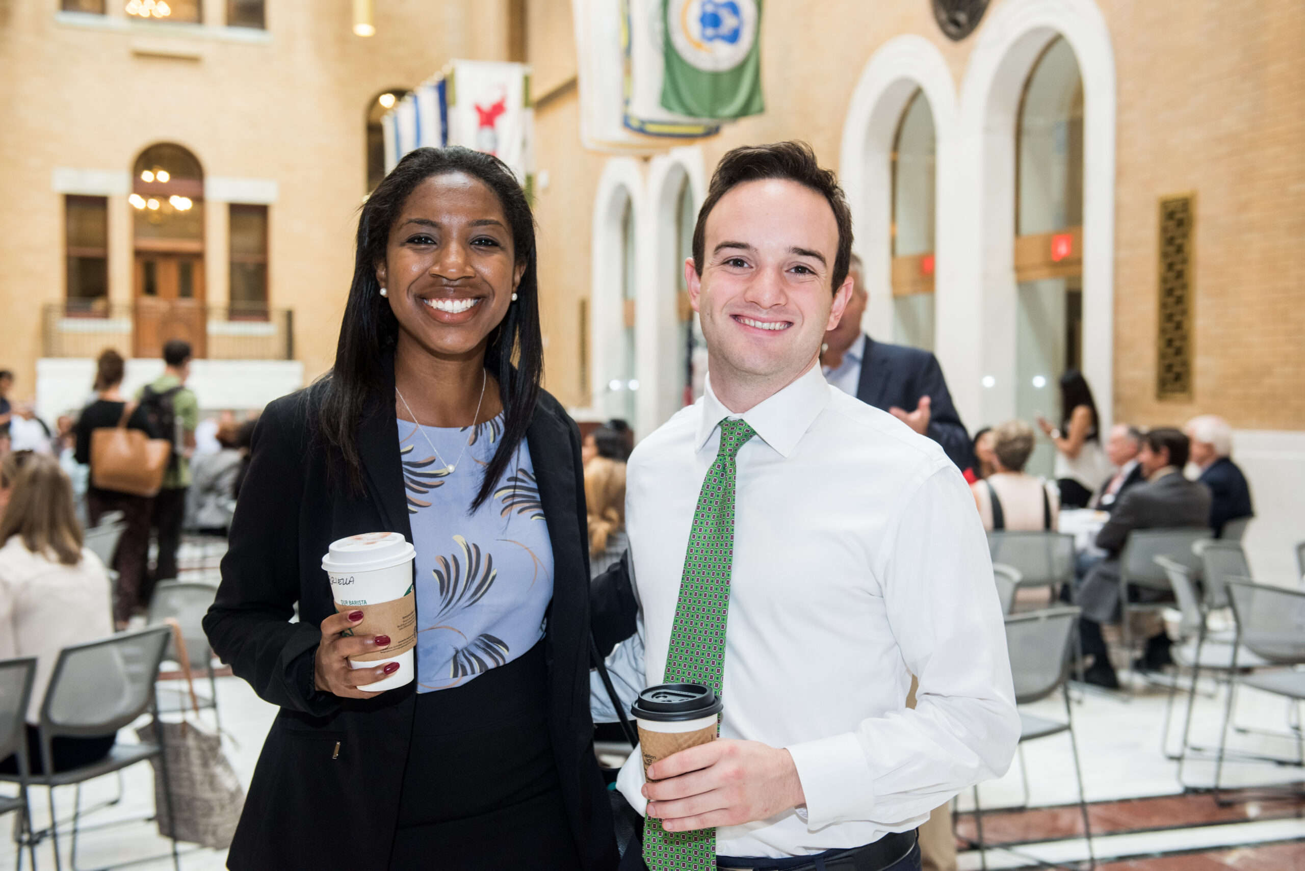 Housing Day 2017-020 Two attendees of CHAPA's Housing Day at the State House posing for a photo in the Great Hall, holding coffees