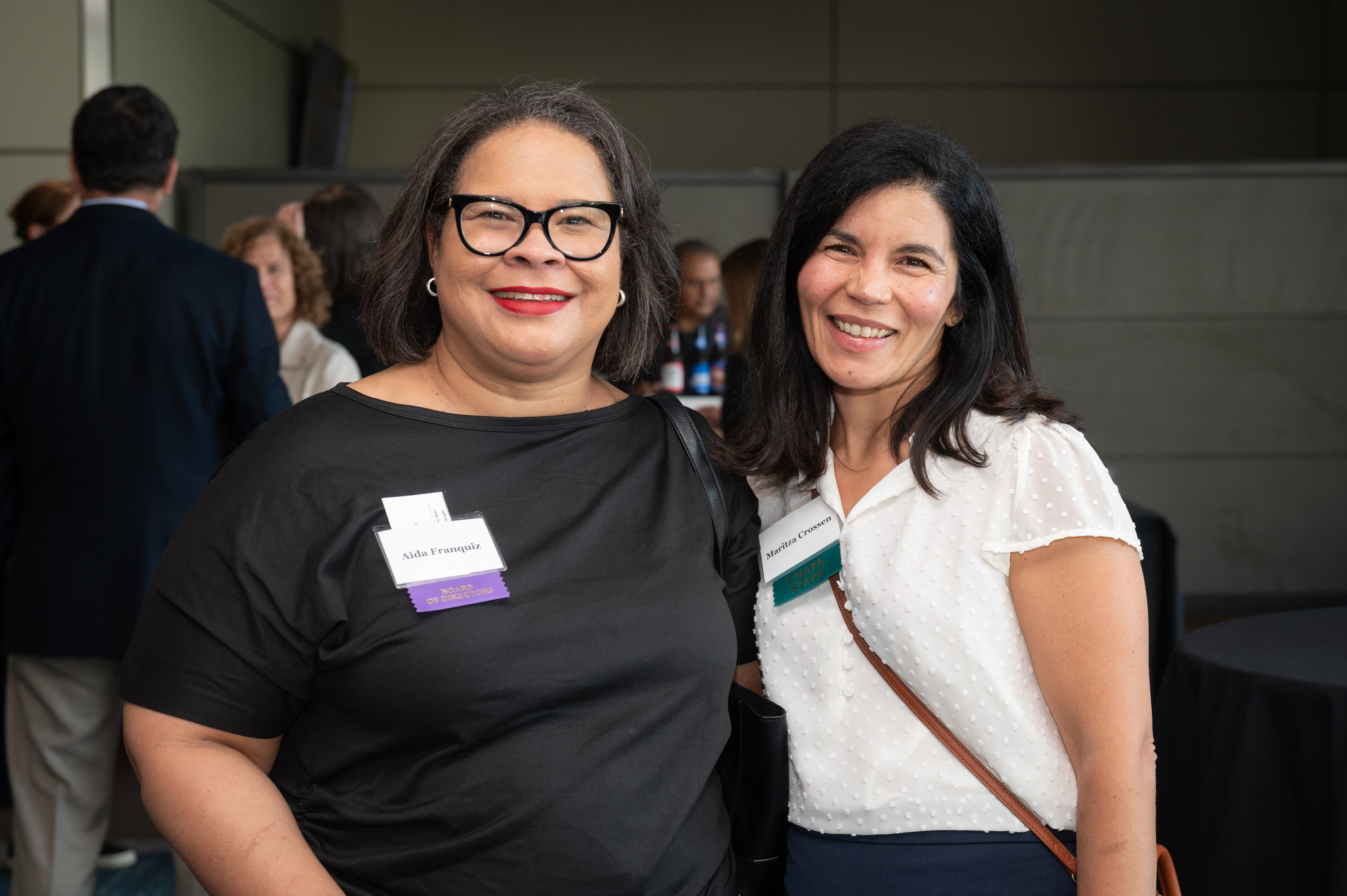 Aida Franquiz and Maritza Crossen posing for a photo and smiling at the CHAPA Dinner Reception